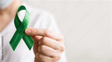 World Lymphoma Awareness Day A Female Doctor Holds Green Ribbon