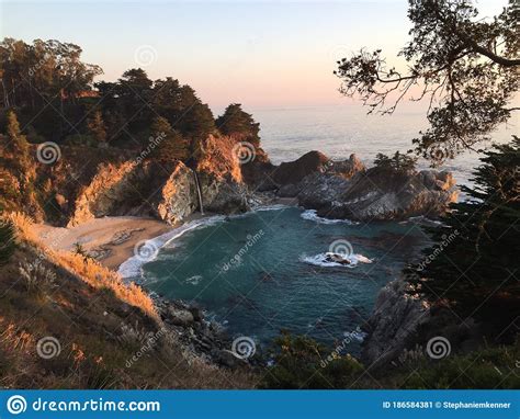 Sunset On Blue Ocean Cove With Waterfall Stock Image Image Of