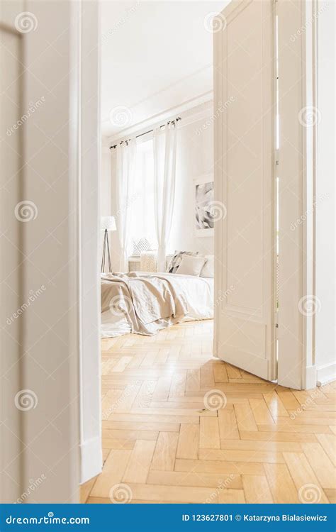 View Through Tall Open White Door On A Stylish Bright Bedroom Stock