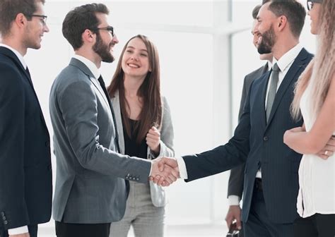 Premium Photo Smiling Business Partners Shaking Hands