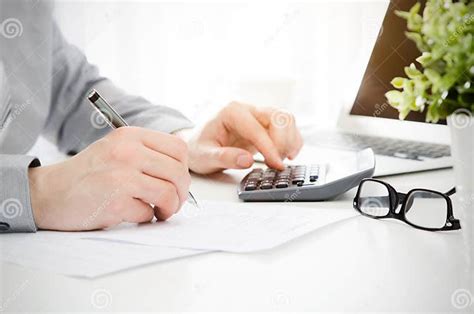 Accountant Calculates Tax Working In The Office With Calculator Stock