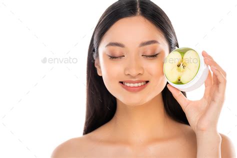 Nude Asian Woman With Closed Eyes Holding Half Of Green Apple Near Face