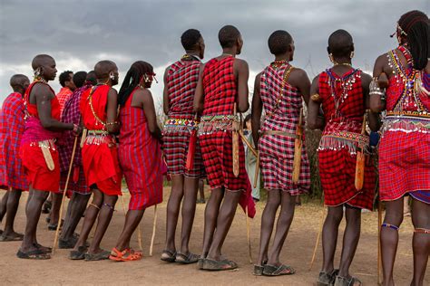 Masai in traditional colorful clothing showing Maasai jumping dance at ...