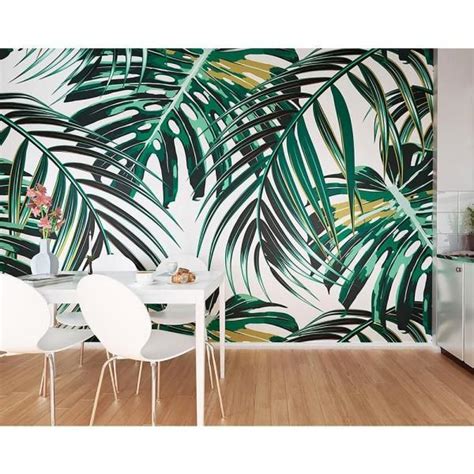 A Dining Room With Palm Leaves On The Wall And White Chairs In Front Of It