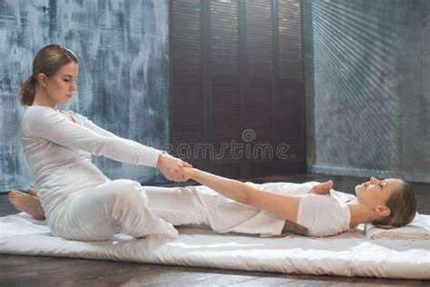 Young Woman Is Getting Thai Massage Treatment By Therapist Traditional