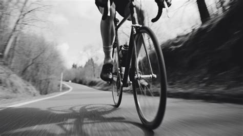 Premium Ai Image A Black And White Photo Of A Person Riding A Bike On