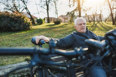 Premium Photo Older Man Sitting On Bench In Park