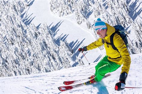 Skier Skiing Downhill In High Mountains Against Sunset Stock Image