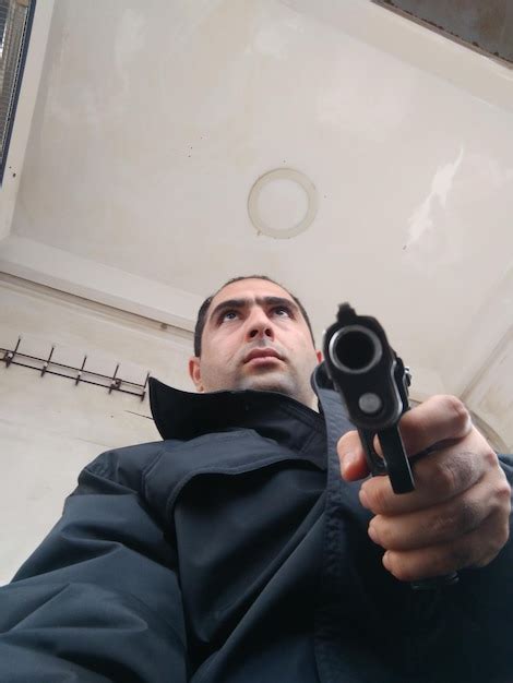 Premium Photo Low Angle View Of Man Aiming Gun