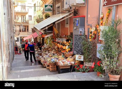 Street with fruit market in Taormina Stock Photo - Alamy