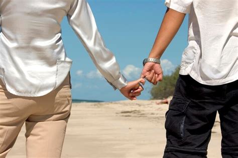 Premium Photo Close Up Of Hands Holding Sand At Beach