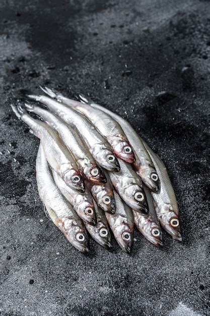 Premium Photo | Raw fresh capelin fish on black table