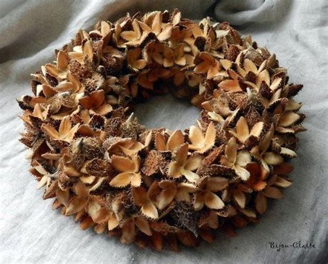 A Wreath Made Out Of Pine Cones Sitting On Top Of A Bed