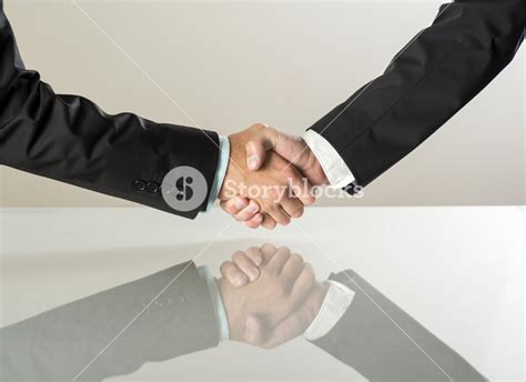 Closeup Of Business People Shaking Hands Over A Deal Royalty Free Stock