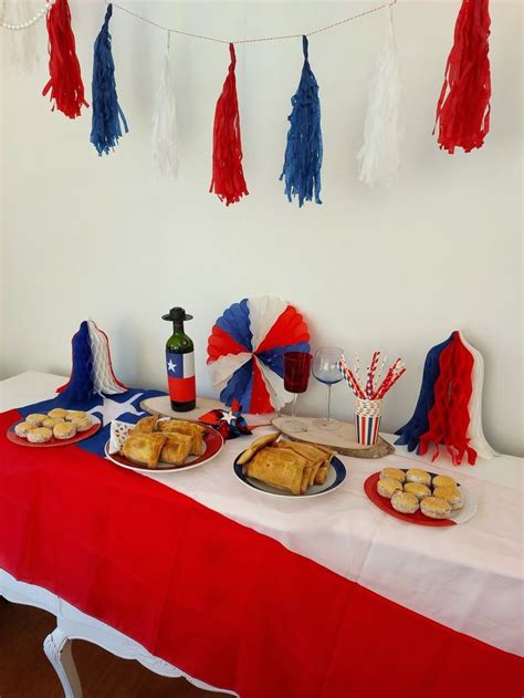 Red White And Blue Desserts On A Table With Tassels Hanging From The