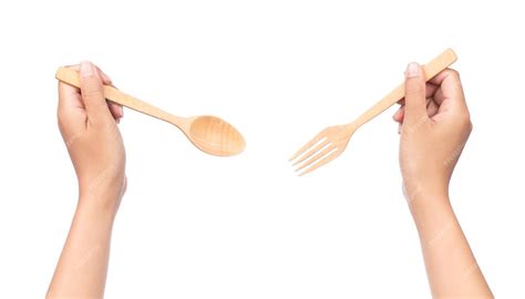 Premium Photo Hand Holding Wood Spoon And Fork Isolated On White