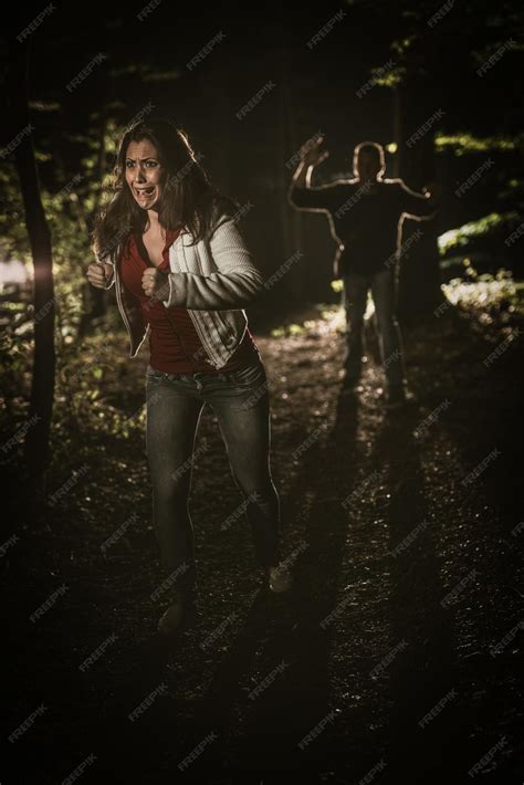 Premium Photo Young Scared Woman Running Through The Forest At Night