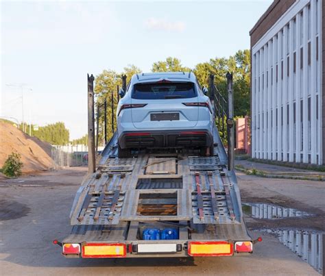 Premium Photo A Car Is On The Back Of A Truck That Has The License