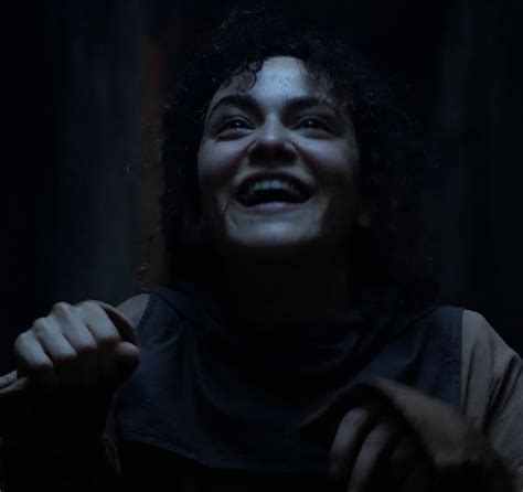 A Man With Curly Hair Laughing In The Dark