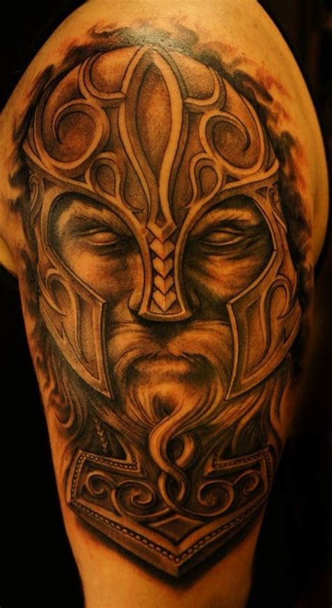 Eyeless Viking warrior in helmet tattoo on shoulder - Tattooimages.biz