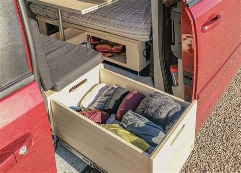 The Interior Of A Red Van With An Open Bed And Storage Compartment In