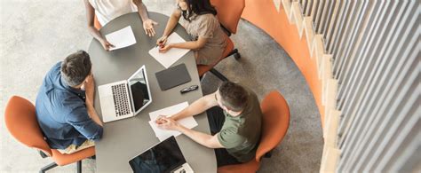 Five Business People Sitting Around Table Discussing High Angle Ahola