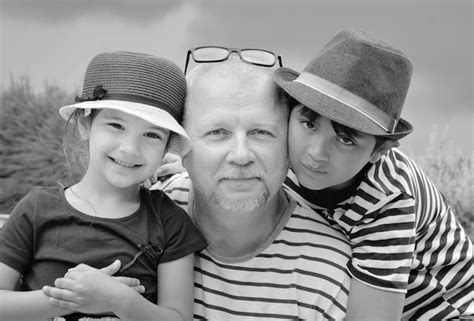 Premium Photo Portrait Of Grandfather With Grandchildren Against Sky