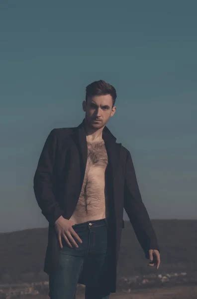 Handsome Man Posing In Unbutton Shirt With Naked Hairy Chest Stock