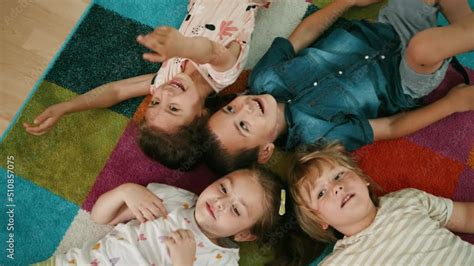 happy children lie   floor  playing funny game