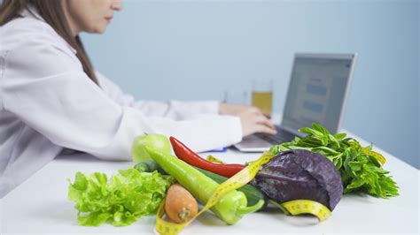 Dietitian preparing diet plan on laptop. 33499393 Stock Video at Vecteezy