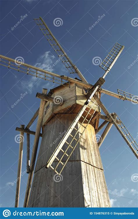 Old Wooden Windmill Against A Blue Sky In Sunny Day Close Up Stock