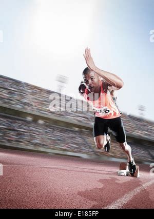 Sprinter Taking Off From The Starting Block Stock Photo Alamy