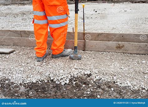 Groundworker Making Shutter For Concrete To Form A Base For Kerb Using