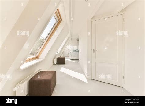 Interior Of Contemporary Bedroom Located On Mansard Of House Designed