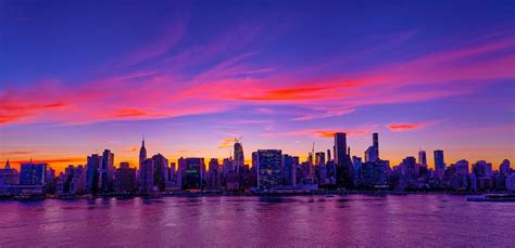 NYC Skyline at Sunset with Pink and Purple Clouds