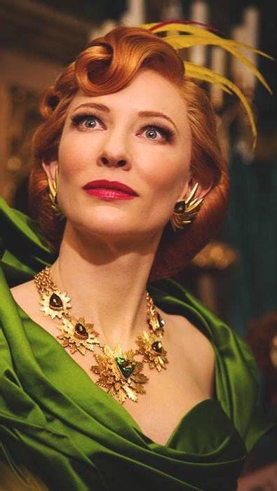 A Woman With Red Hair Wearing A Green Dress And Gold Jewelry Is Looking