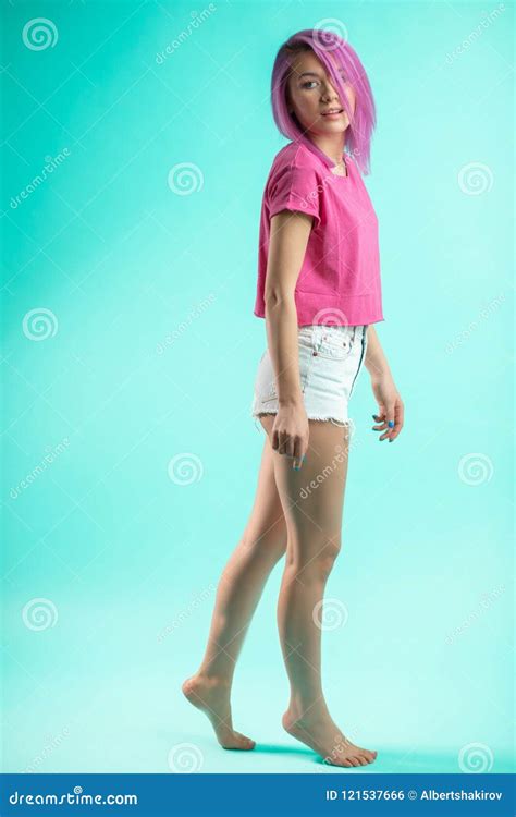 Slim Fit Sporty Active Woman In Denim Shorts Looking At Camera Isolated