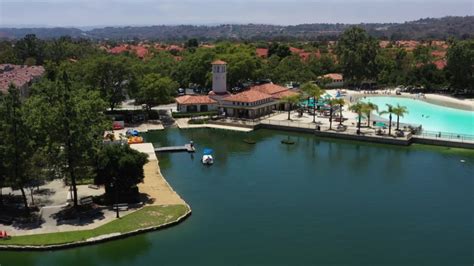 Boat on Rancho Santa Margarita Lake with man made beach | ClipStock