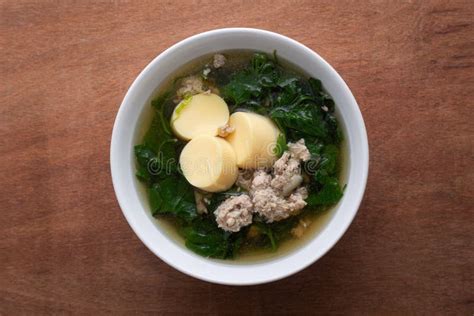 Boiled Minced Pork And Tofu Soup With Gourd In White Bowl On Wooden