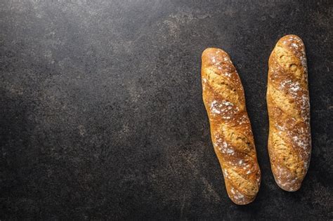 Premium Photo Crispy Fresh Baguettes On Black Table Top View