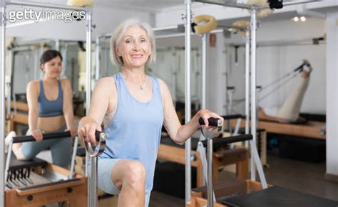 Sporty Elderly Woman Practicing Pilates Exercises On Combo Chair