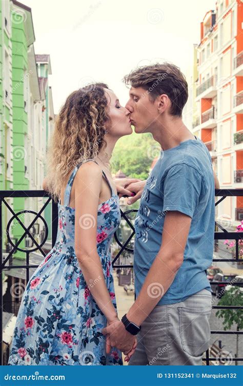 Beautiful Heterosexual Couple Kisses On The Balcony Multicolored Urban