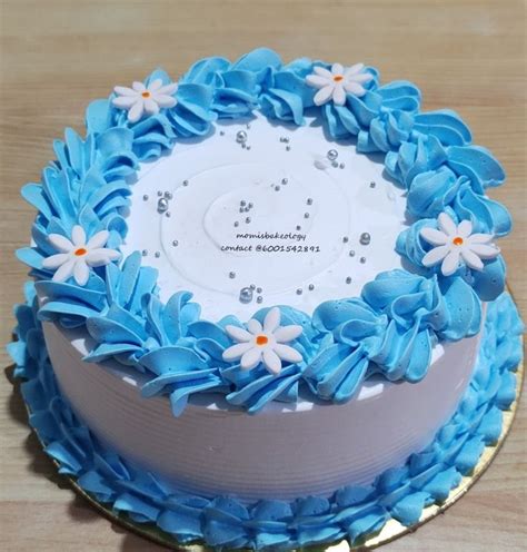 Simple Cake Design with Blue Icing and White Flowers