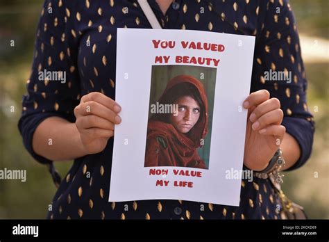 A Protester Holds The Famous Afghan Girl Photo A 1984 Photographic