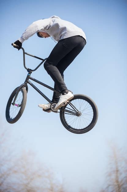 Premium Photo A Bmx Rider In The Skatepark Performing A Trick In The Air