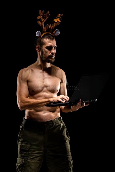 Strong Muscular Man with Deer Antlers Holding Laptop Isolated on Black ...