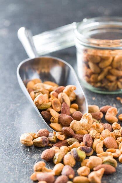 Premium Photo Spicy Flavoured Nuts Mix Of Nuts In Scoop