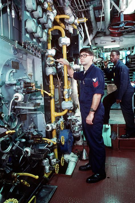 Boiler Technicians Monitor Gauges In The Boiler Room Of The Battleship