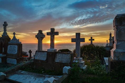 Royalty-Free photo: Cemetery by the sea under blue and orange sky ...