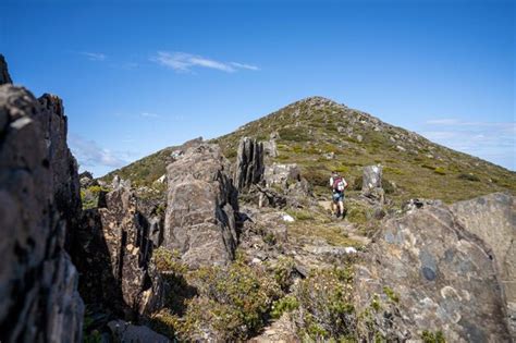 Premium Photo Man Hiking Up A Mountain With A Backpack